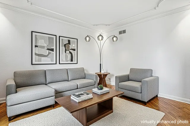 a living room with furniture a couch and paintings on the wall