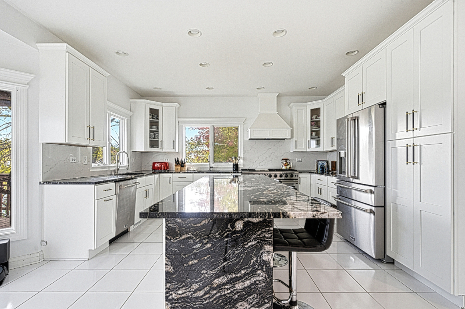 220 Santos Avenue Minooka, IL 60447 - Photo 8 of 46 a large kitchen with granite countertop a refrigerator oven a sink a stove and white cabinets