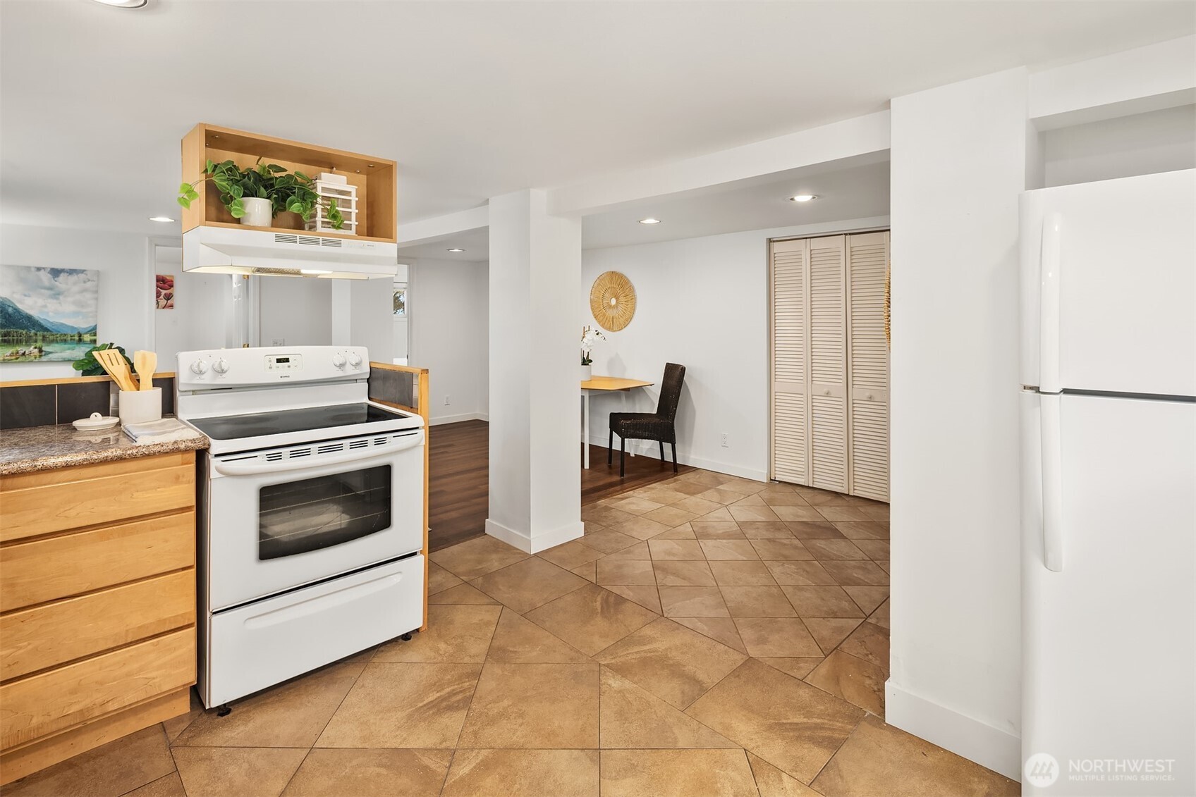 1341 North 78th Street Seattle, WA 98103 - Photo 17 of 23 a kitchen with a stove a refrigerator and cabinets