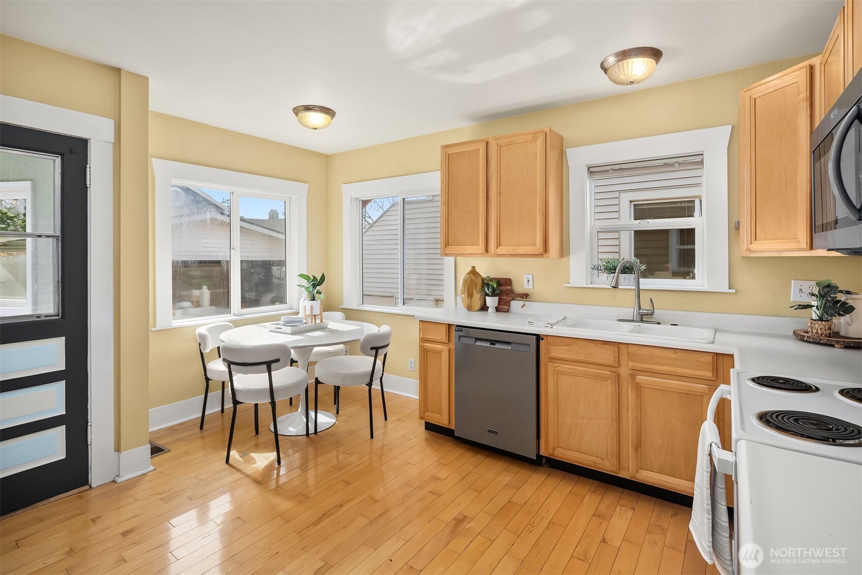 1341 North 78th Street Seattle, WA 98103 - Photo 5 of 23 a kitchen with a sink stove and cabinets
