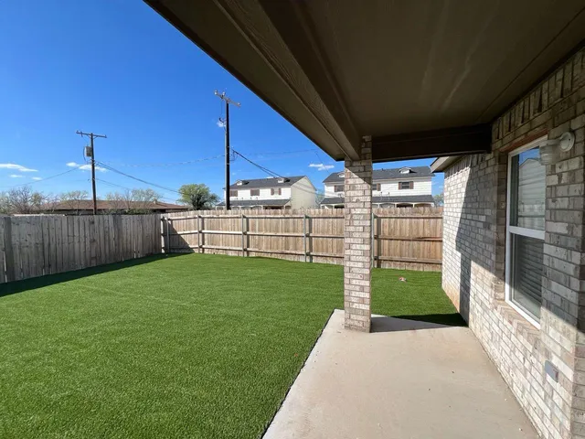 a view of a backyard with pathway