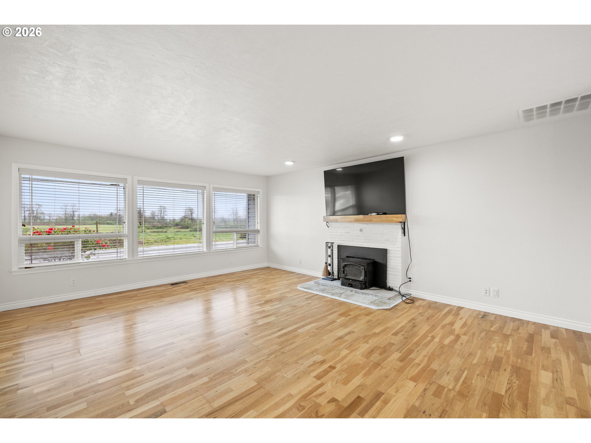 5720 Sollie Smith Road North Tillamook, OR 97141 - Photo 11 of 44 a view of empty room with wooden floor and fireplace