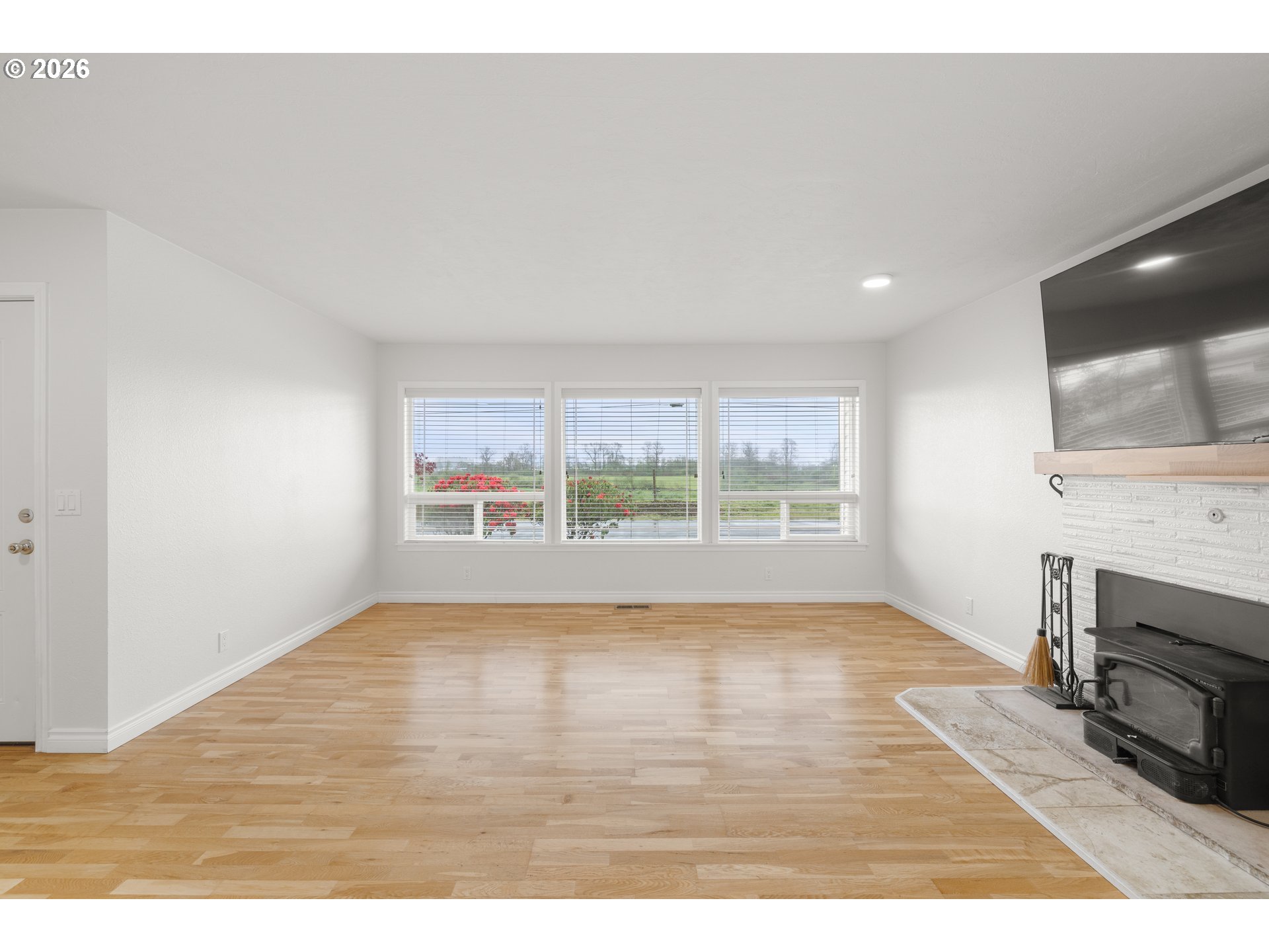 5720 Sollie Smith Road North Tillamook, OR 97141 - Photo 12 of 44 a view of empty room with wooden floor and fireplace