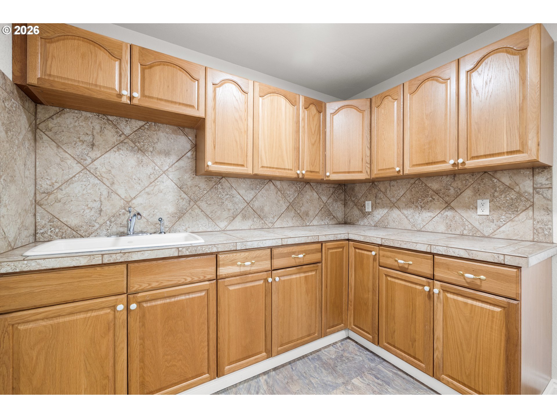 5720 Sollie Smith Road North Tillamook, OR 97141 - Photo 16 of 44 a kitchen with granite countertop a sink cabinets and window