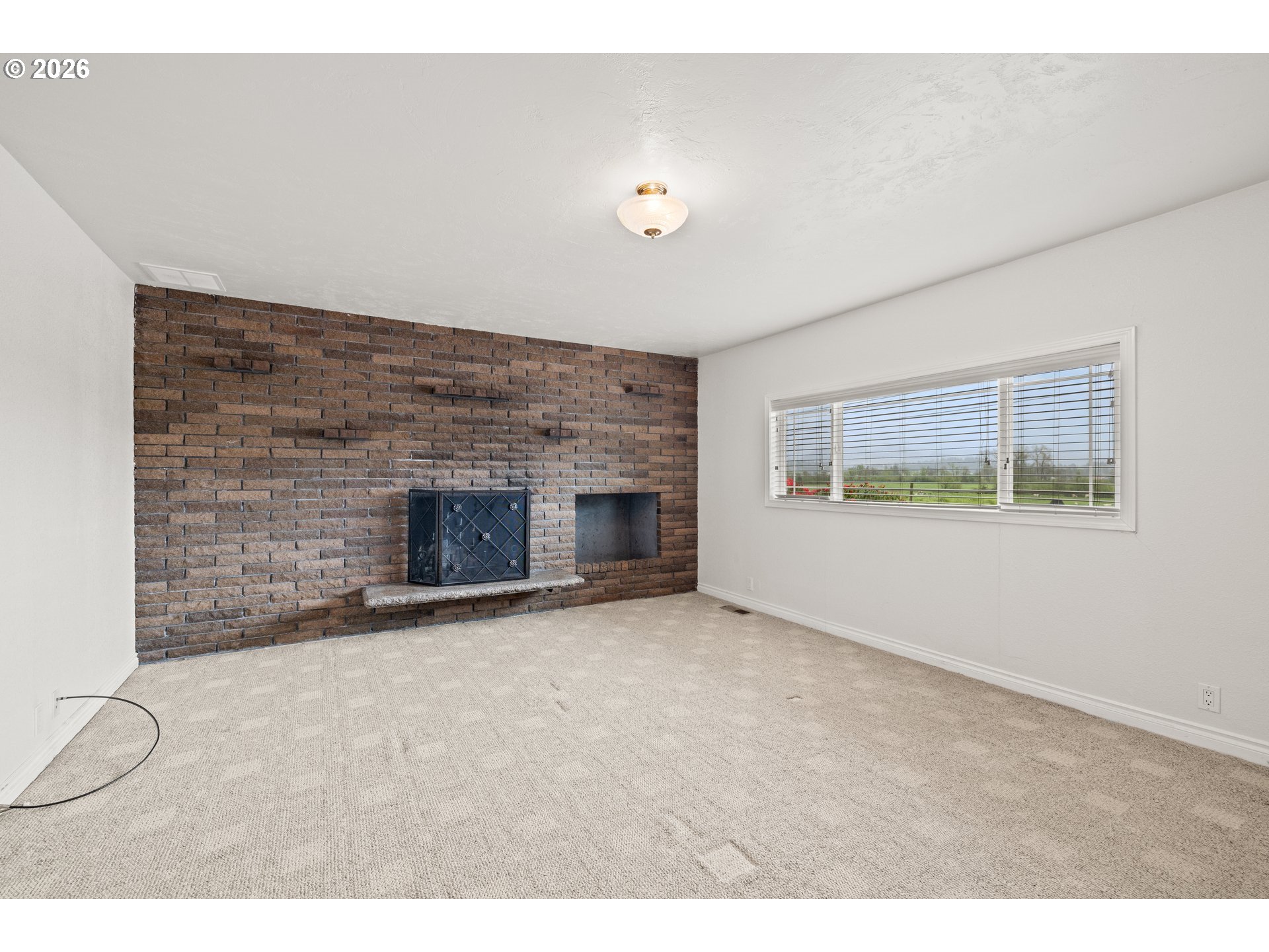 5720 Sollie Smith Road North Tillamook, OR 97141 - Photo 20 of 44 a view of an empty room with a fireplace and a window