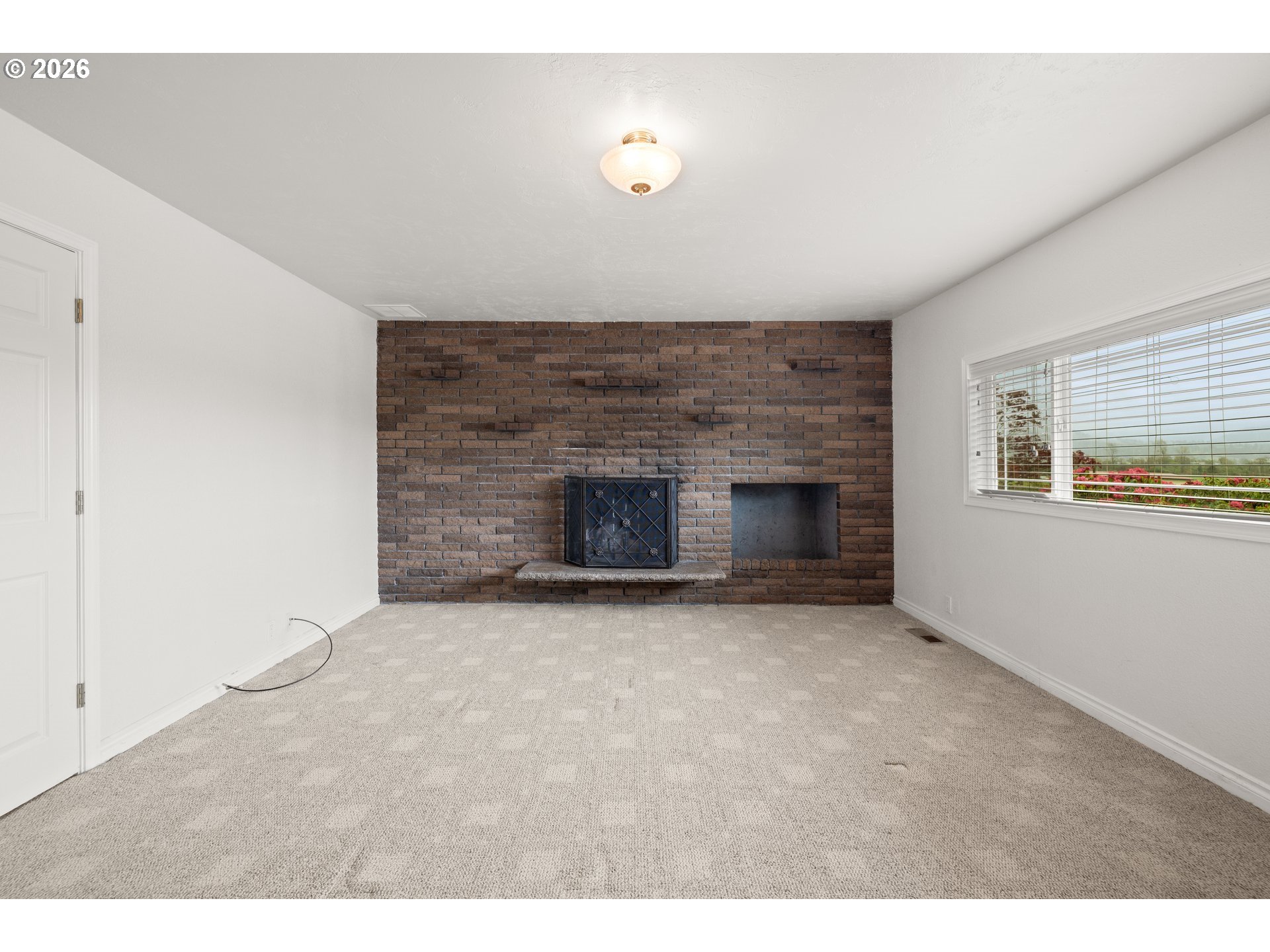 5720 Sollie Smith Road North Tillamook, OR 97141 - Photo 21 of 44 a view of empty room with a fireplace