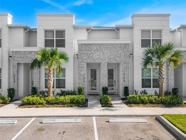 front view of a house with potted plants