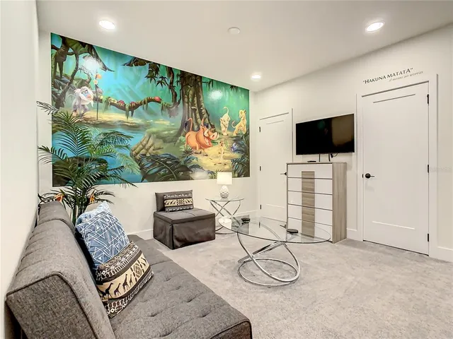 an aerial view of a house with outdoor space and lake view in back