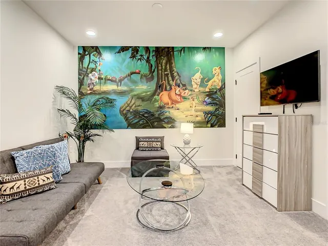 a living room with furniture and a potted plant