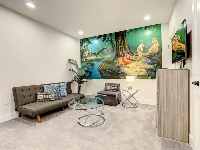 a living room with furniture and a potted plant