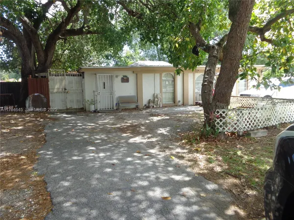 a view of a house with a tree in front of it