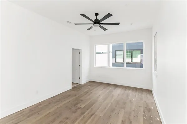 an empty room and closet area with wooden floor