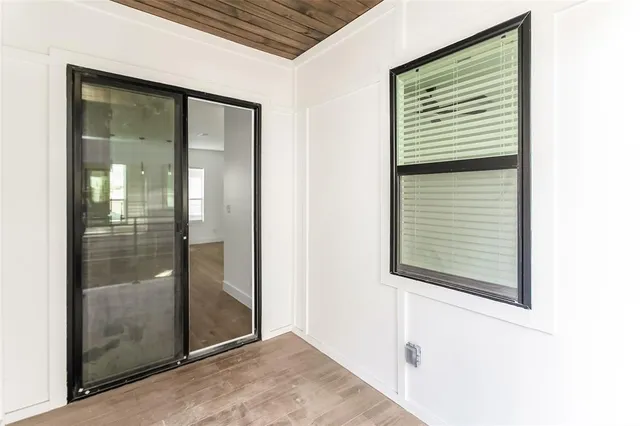 an empty room with a window and a fan