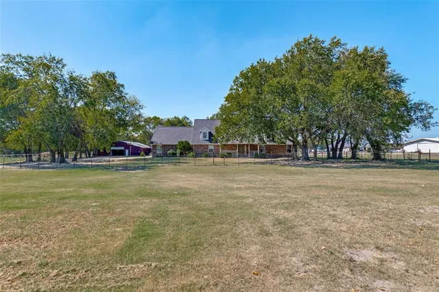 a view of outdoor space with garden and trees