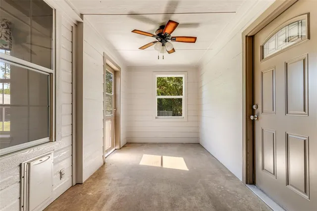 a view of entryway and hall with a chandelier fan