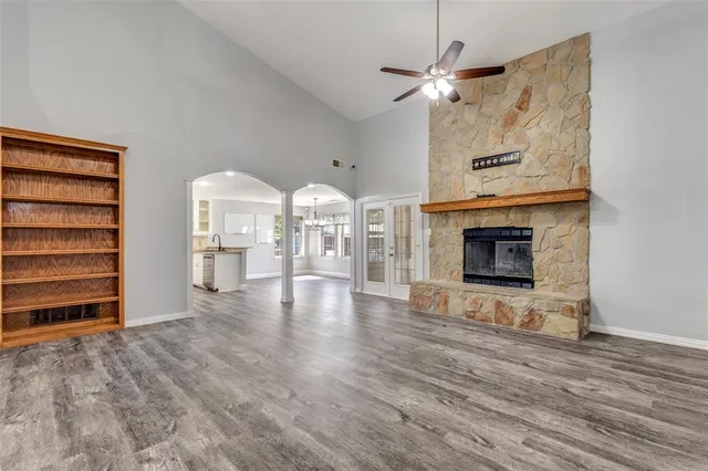 a view of an empty room with fire place and a fireplace