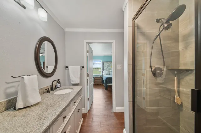 a bathroom with a granite countertop sink mirror and tub