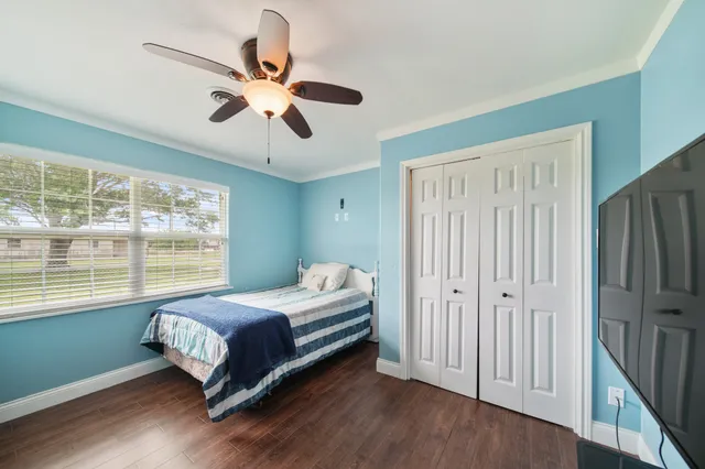 a bedroom with a bed and a window