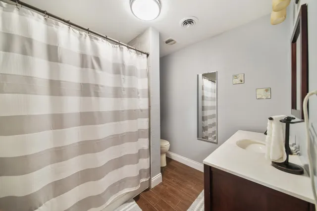a bathroom with a sink a mirror and a shower curtain