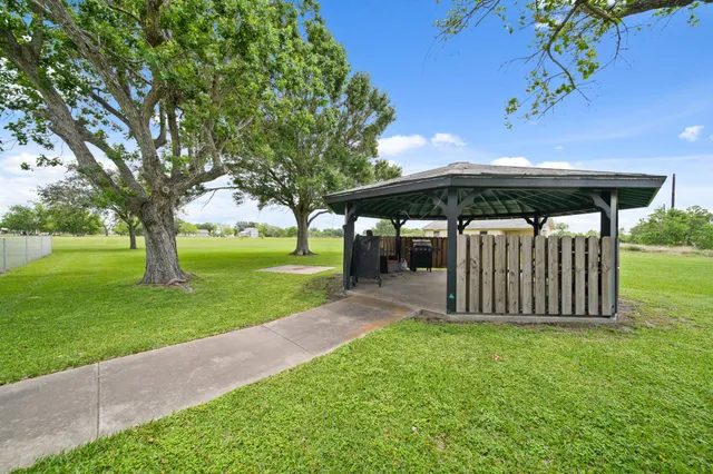 a view of a backyard with large trees