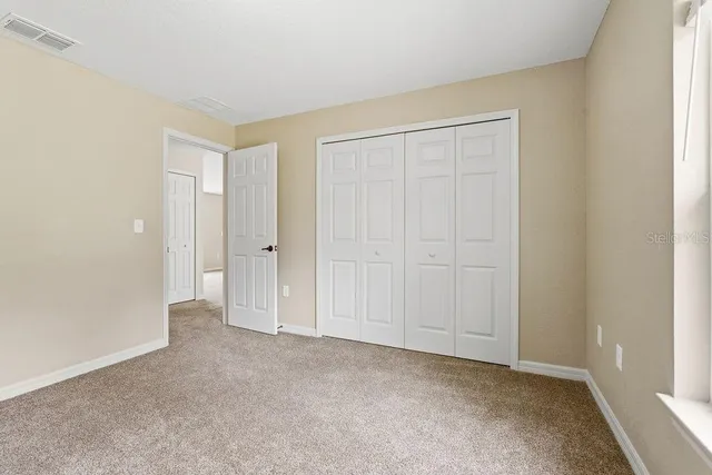 an empty room with closet area