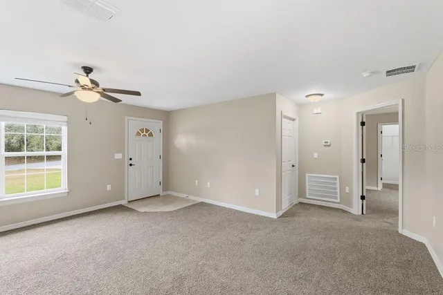 a view of an empty room with a window