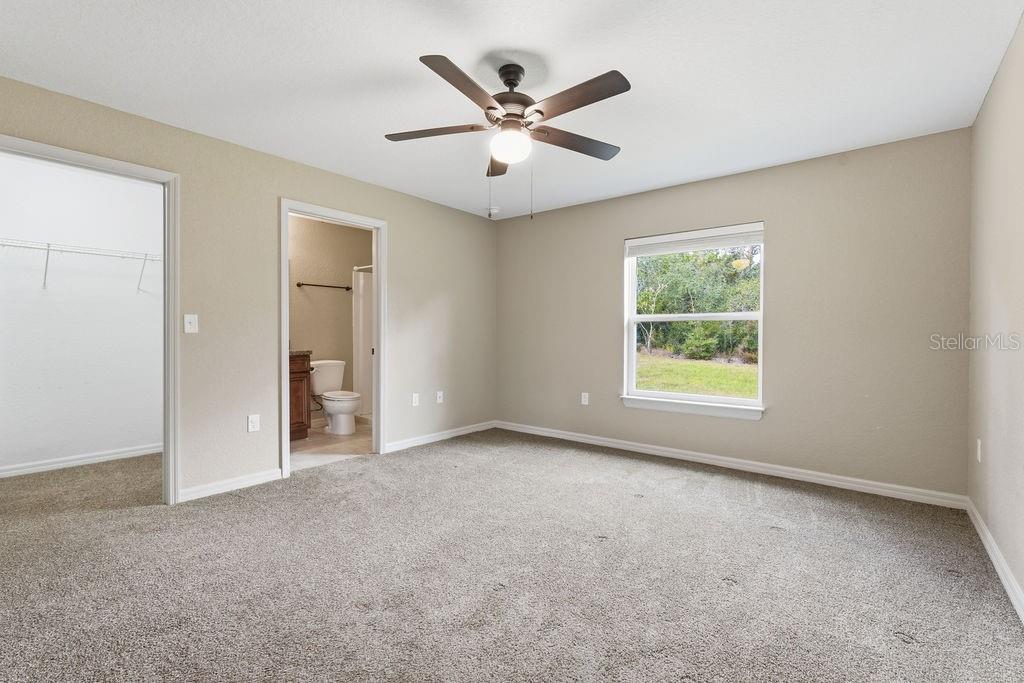 16592 Southwest 31st Circle Ocala, FL 34473 - Photo 18 of 27 an empty room with windows and ceiling fan