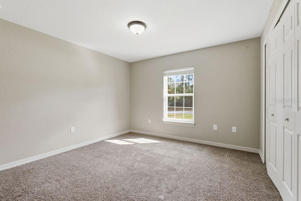 16592 Southwest 31st Circle Ocala, FL 34473 - Photo 9 of 27 a view of a big room with windows and chandelier fan