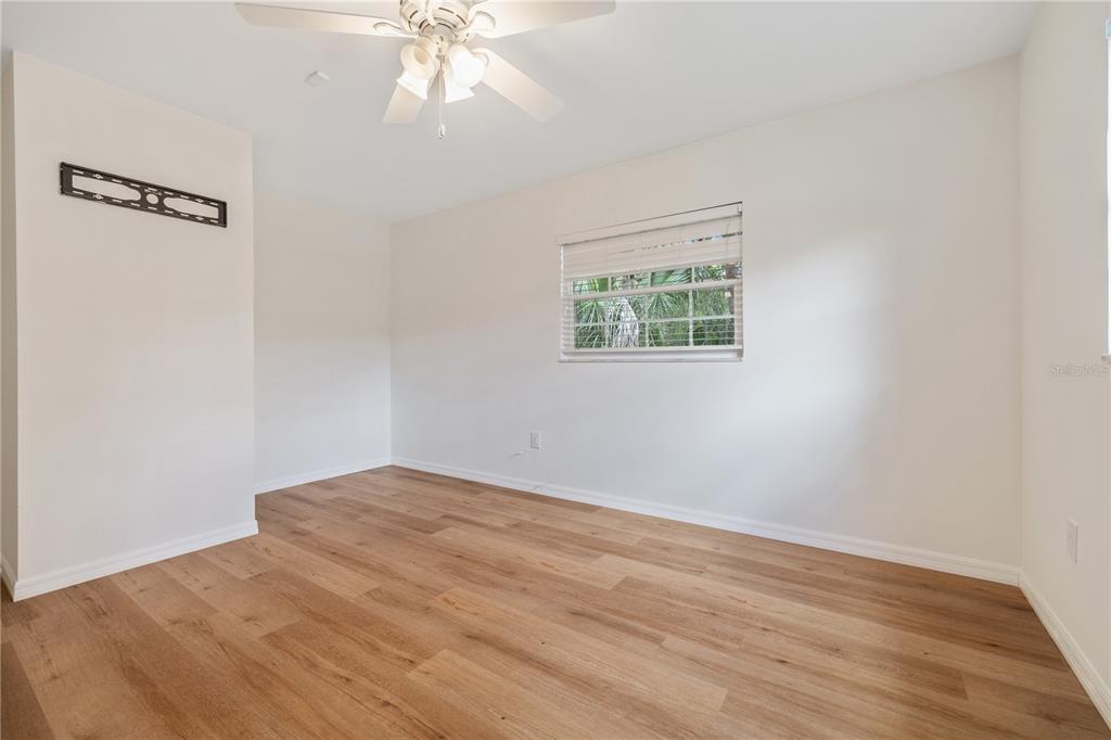 8916 Memorial Highway Tampa, FL 33615 - Photo 12 of 26 a view of an empty room with wooden floor and a window