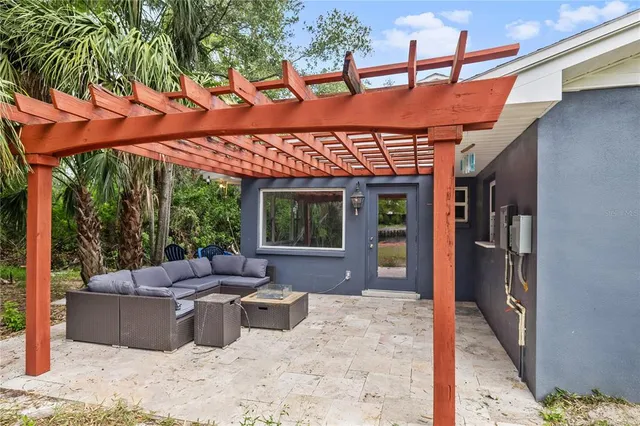 a view of a patio with a table and chairs under an umbrella