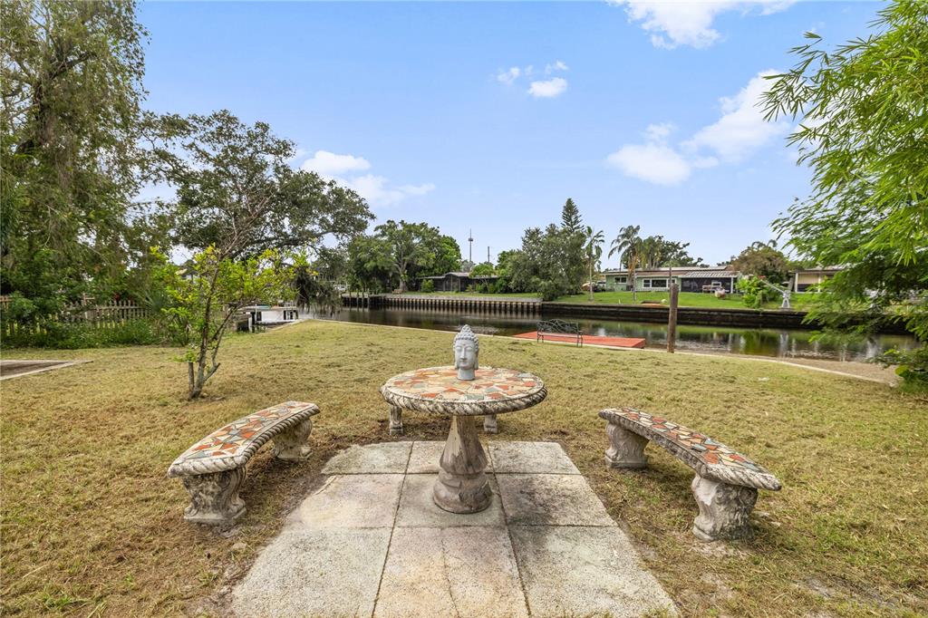 8916 Memorial Highway Tampa, FL 33615 - Photo 24 of 26 a view of a lake with a yard and large trees