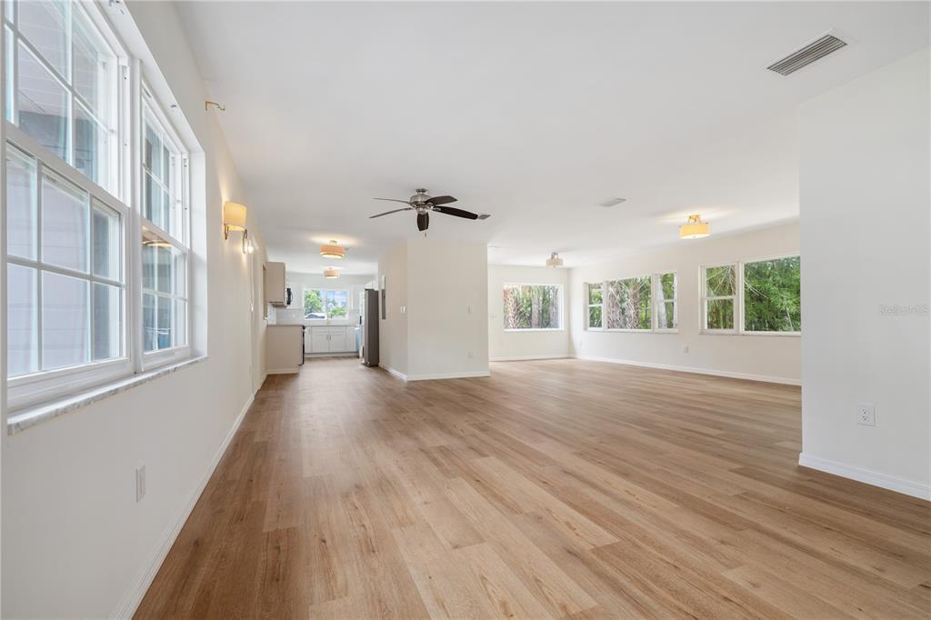 8916 Memorial Highway Tampa, FL 33615 - Photo 3 of 26 a view of an empty room with wooden floor and a window