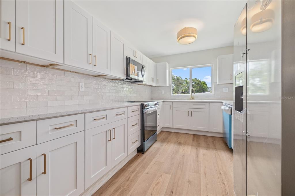 8916 Memorial Highway Tampa, FL 33615 - Photo 8 of 26 a kitchen with white cabinets and sink