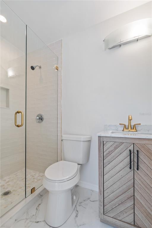 8916 Memorial Highway Tampa, FL 33615 - Photo 10 of 26 a bathroom with a toilet a sink and shower