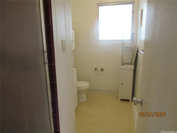 a bathroom with a granite countertop toilet a sink and shower