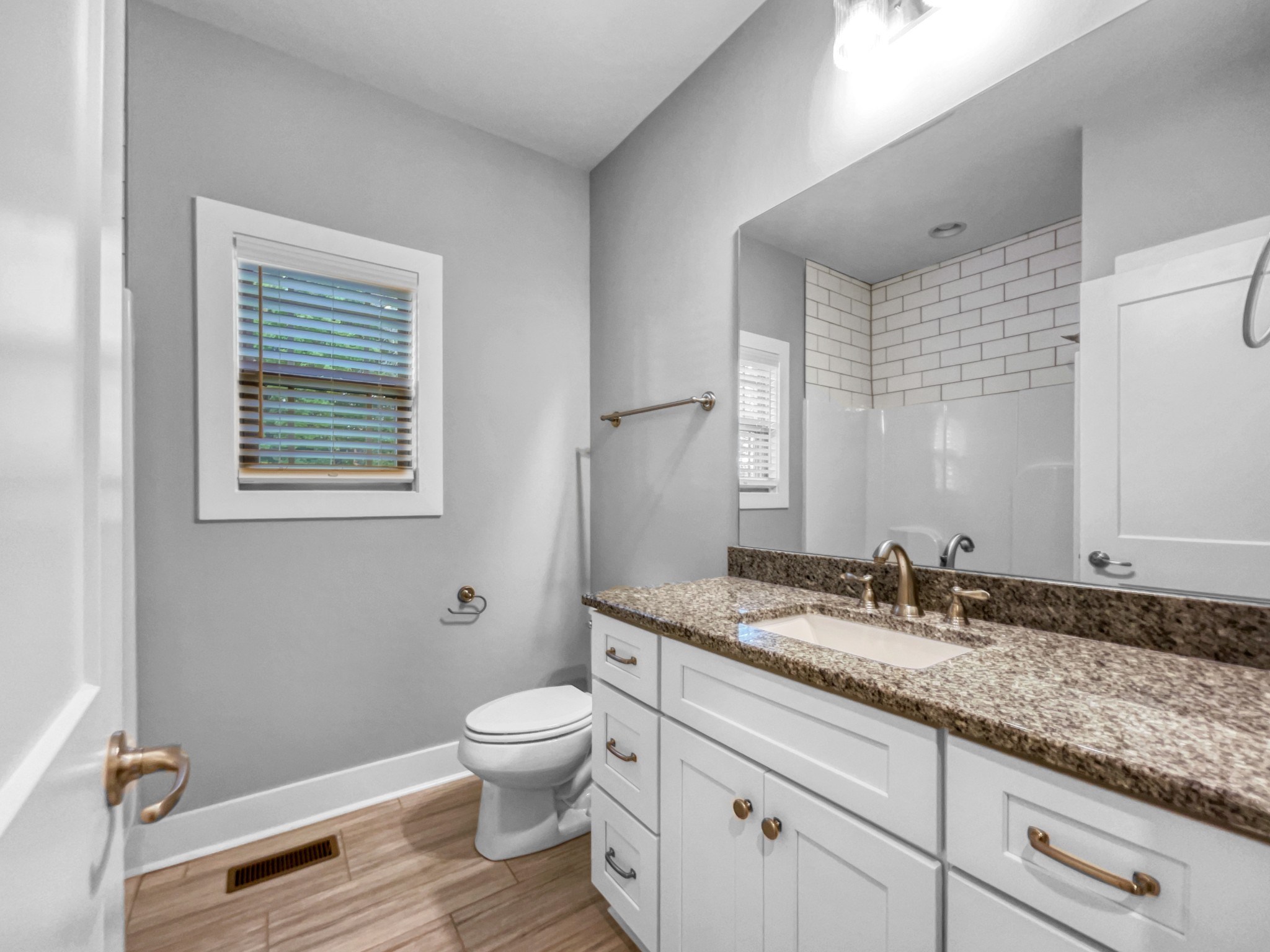 6650 Murfreesboro Road Lebanon, TN 37090 - Photo 15 of 27 a bathroom with a granite countertop sink a toilet and a mirror