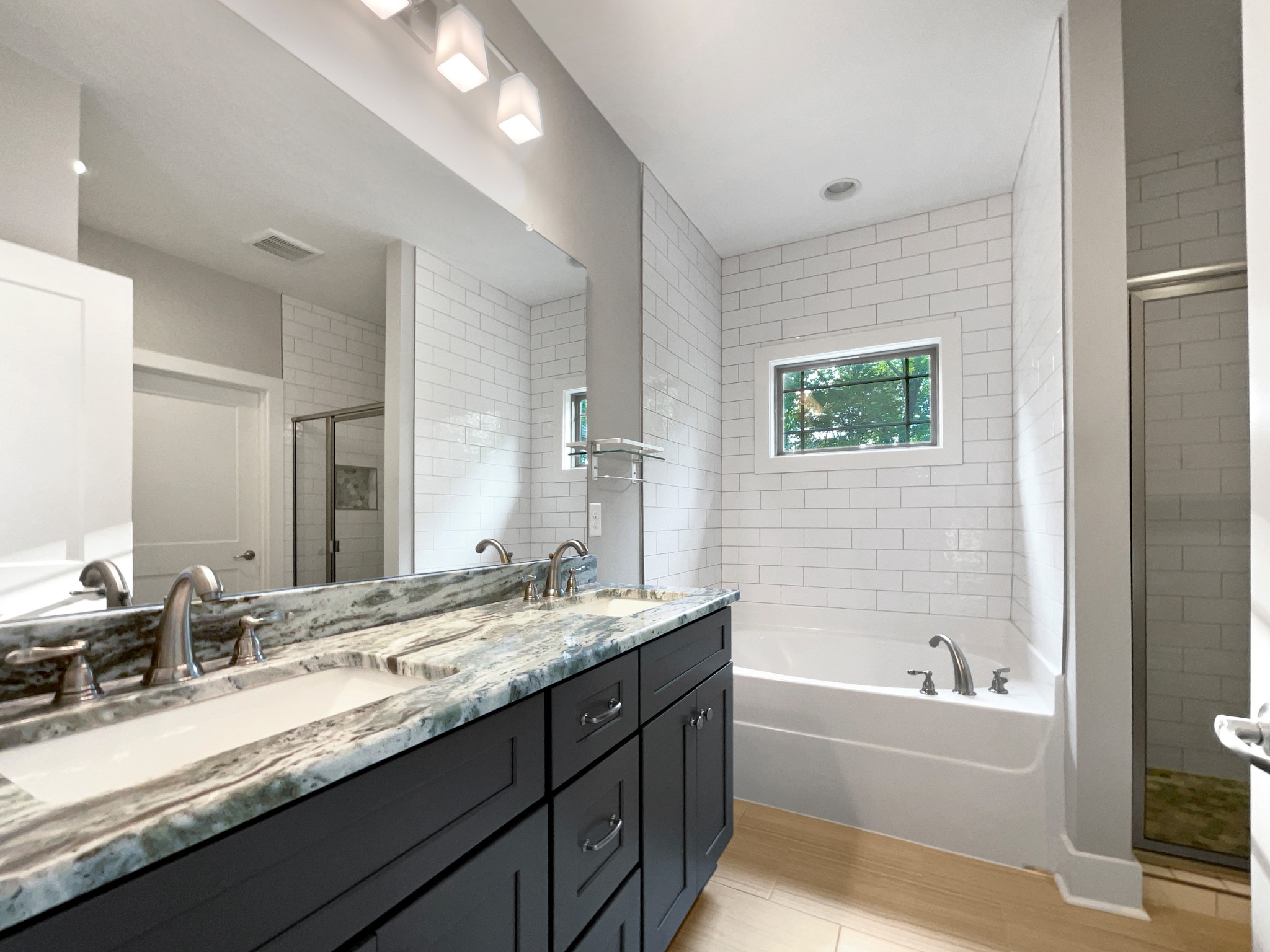 6650 Murfreesboro Road Lebanon, TN 37090 - Photo 20 of 27 a bathroom with a granite countertop bathtub sink double vanity and mirror