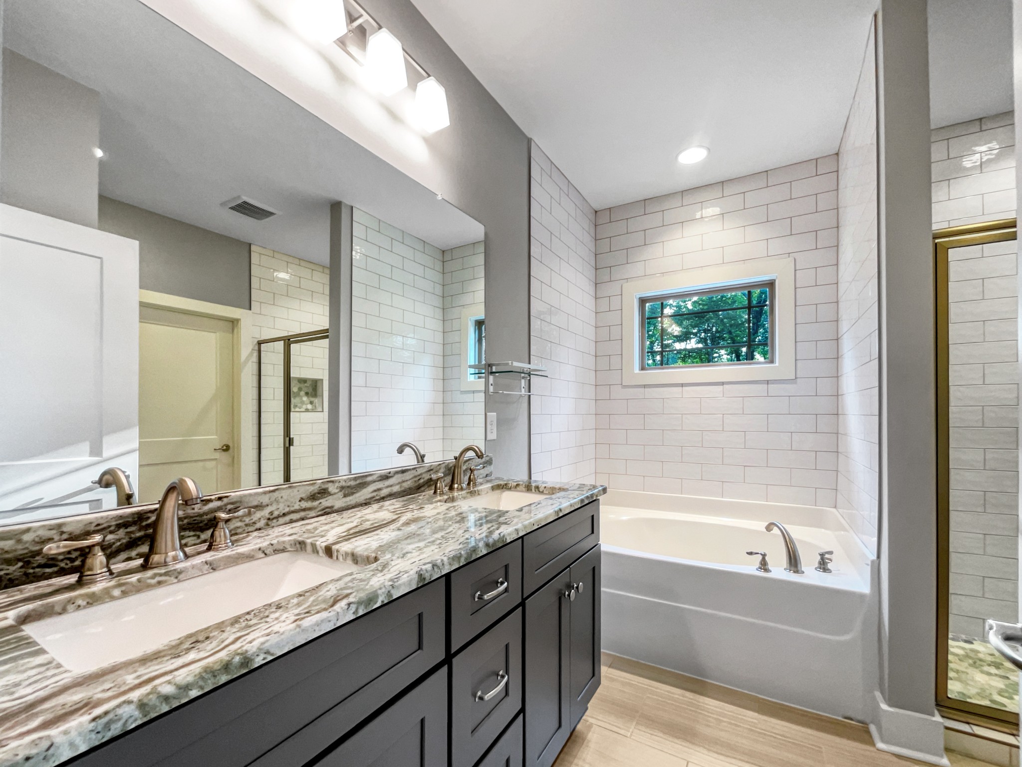 6650 Murfreesboro Road Lebanon, TN 37090 - Photo 21 of 27 a bathroom with a granite countertop tub sink double vanity and mirror