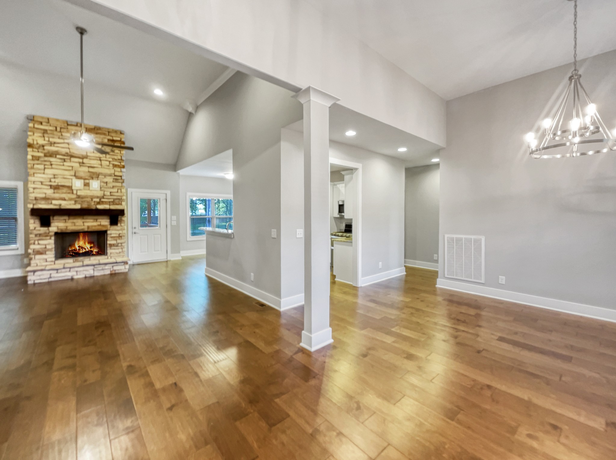 6650 Murfreesboro Road Lebanon, TN 37090 - Photo 8 of 27 a view of a livingroom with a fireplace a chandelier and wooden floor