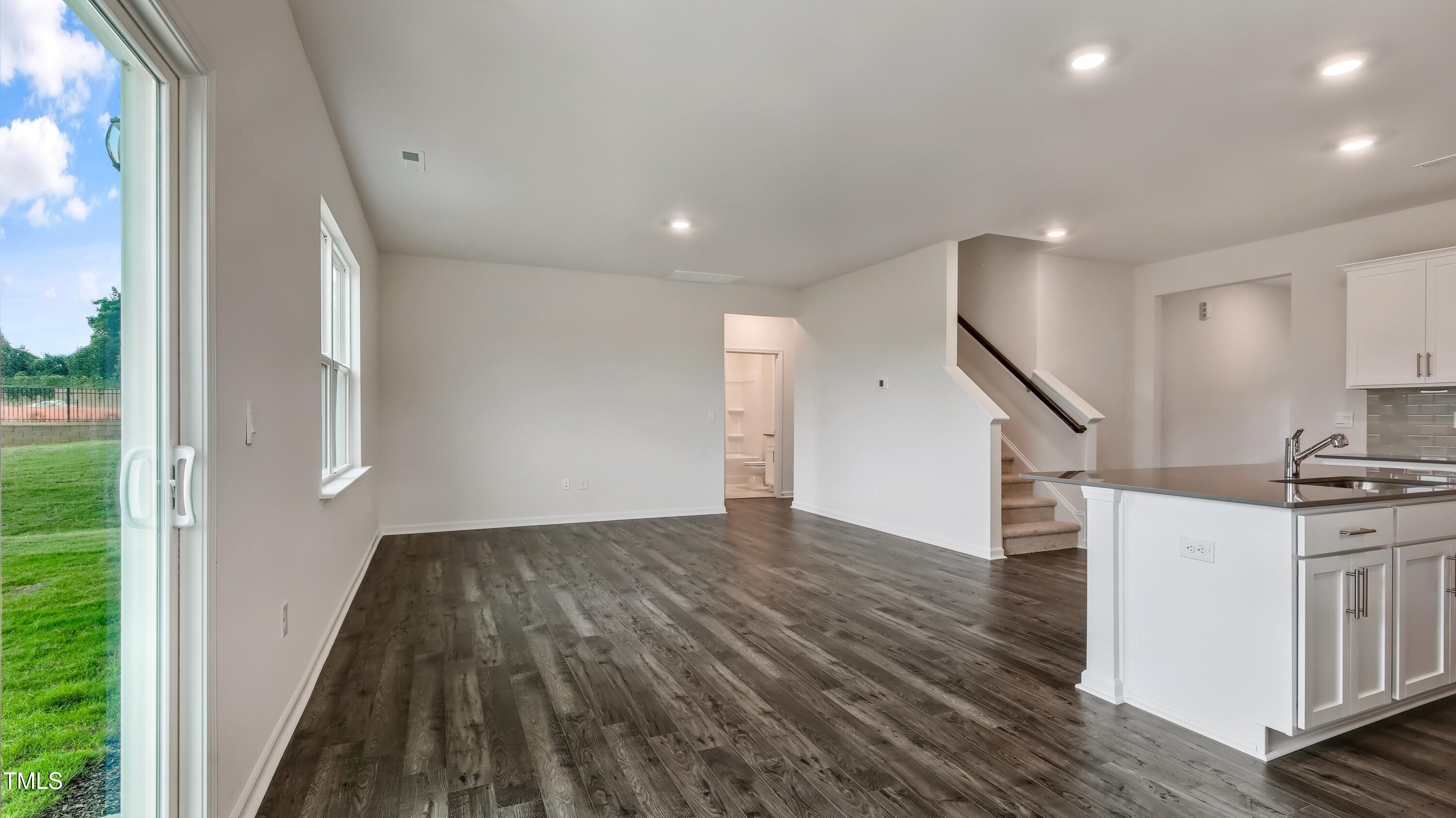821 Comice Pear Way Willow Spring, NC 27592 - Photo 11 of 36 a view of a kitchen with wooden floor and electronic appliances