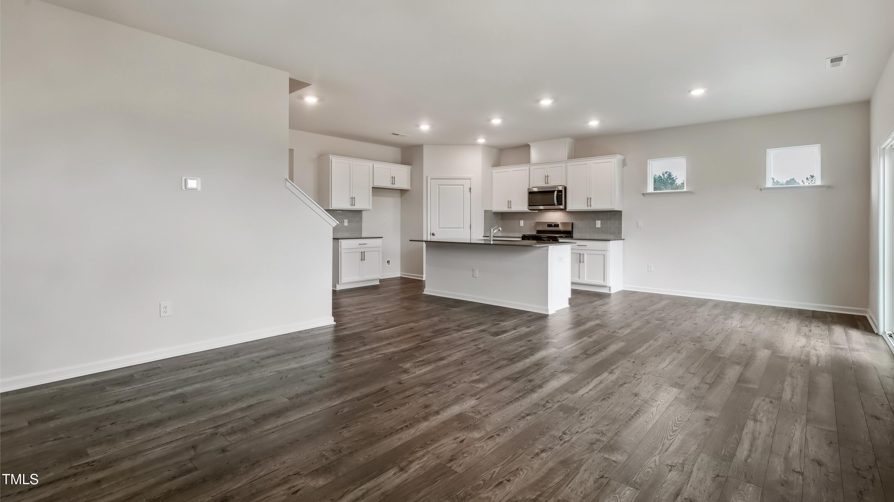 821 Comice Pear Way Willow Spring, NC 27592 - Photo 13 of 36 a view of kitchen with wooden floor and window