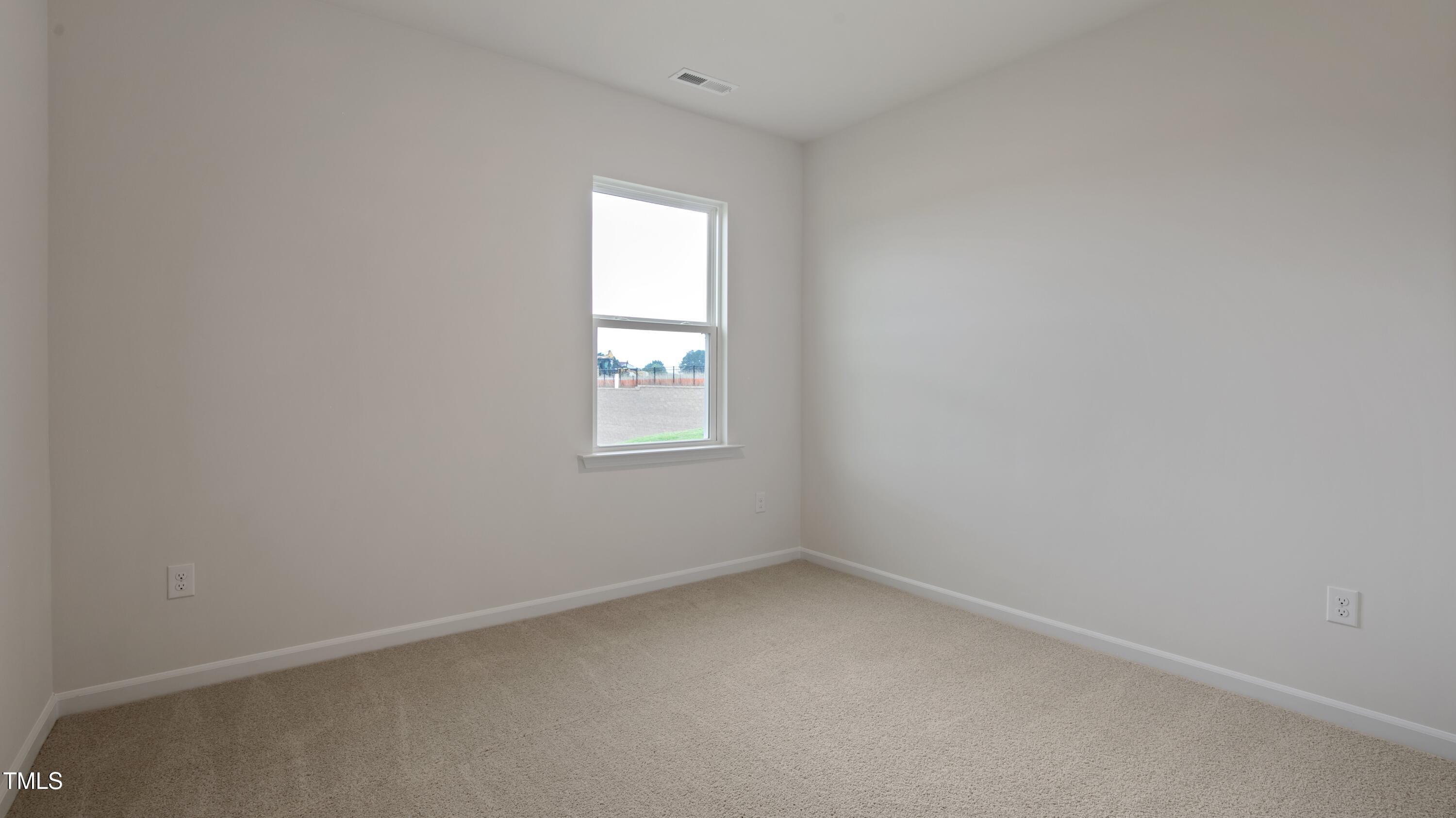 821 Comice Pear Way Willow Spring, NC 27592 - Photo 21 of 36 an empty room with a window