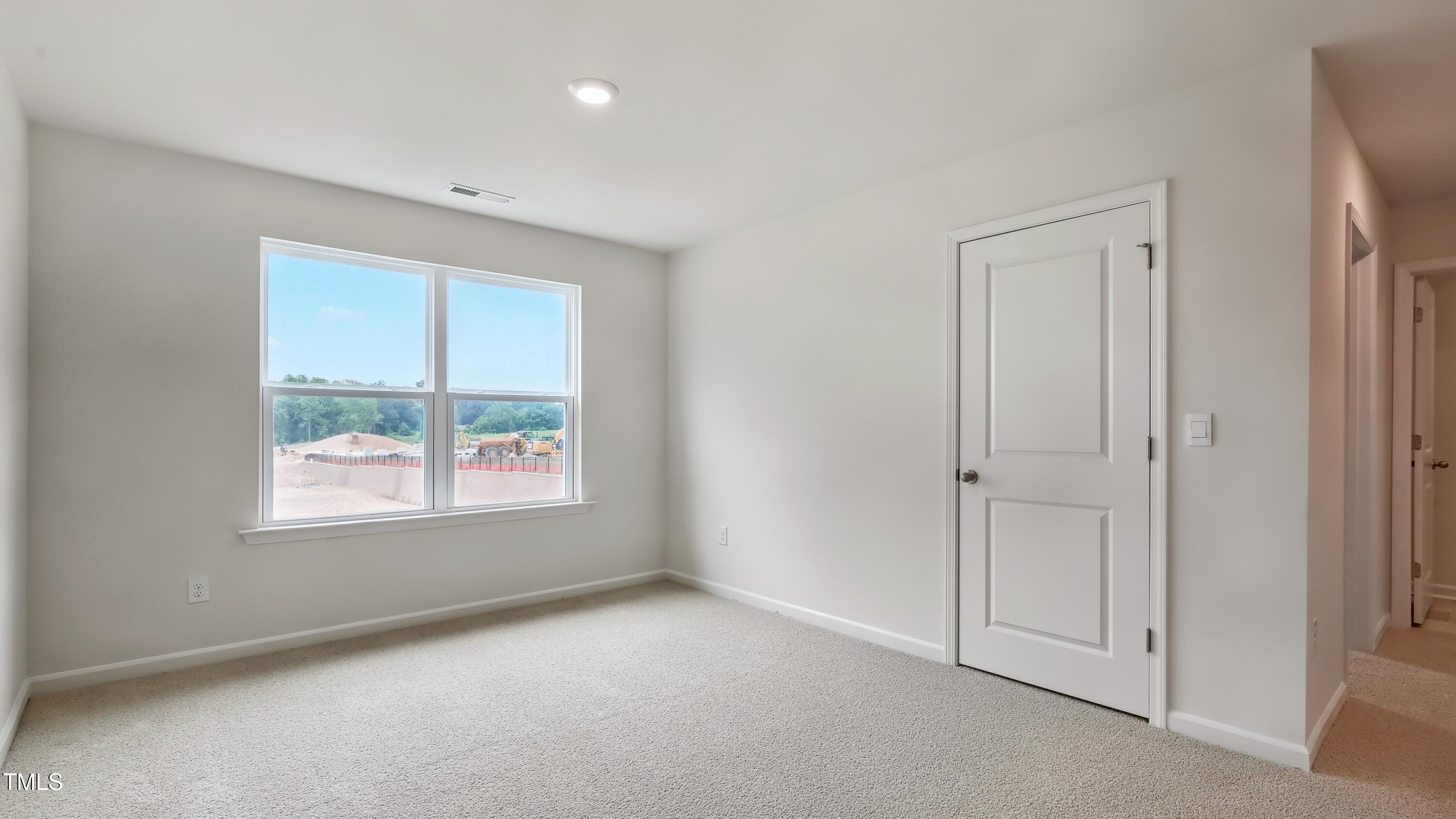 821 Comice Pear Way Willow Spring, NC 27592 - Photo 23 of 36 an empty room with windows and closet