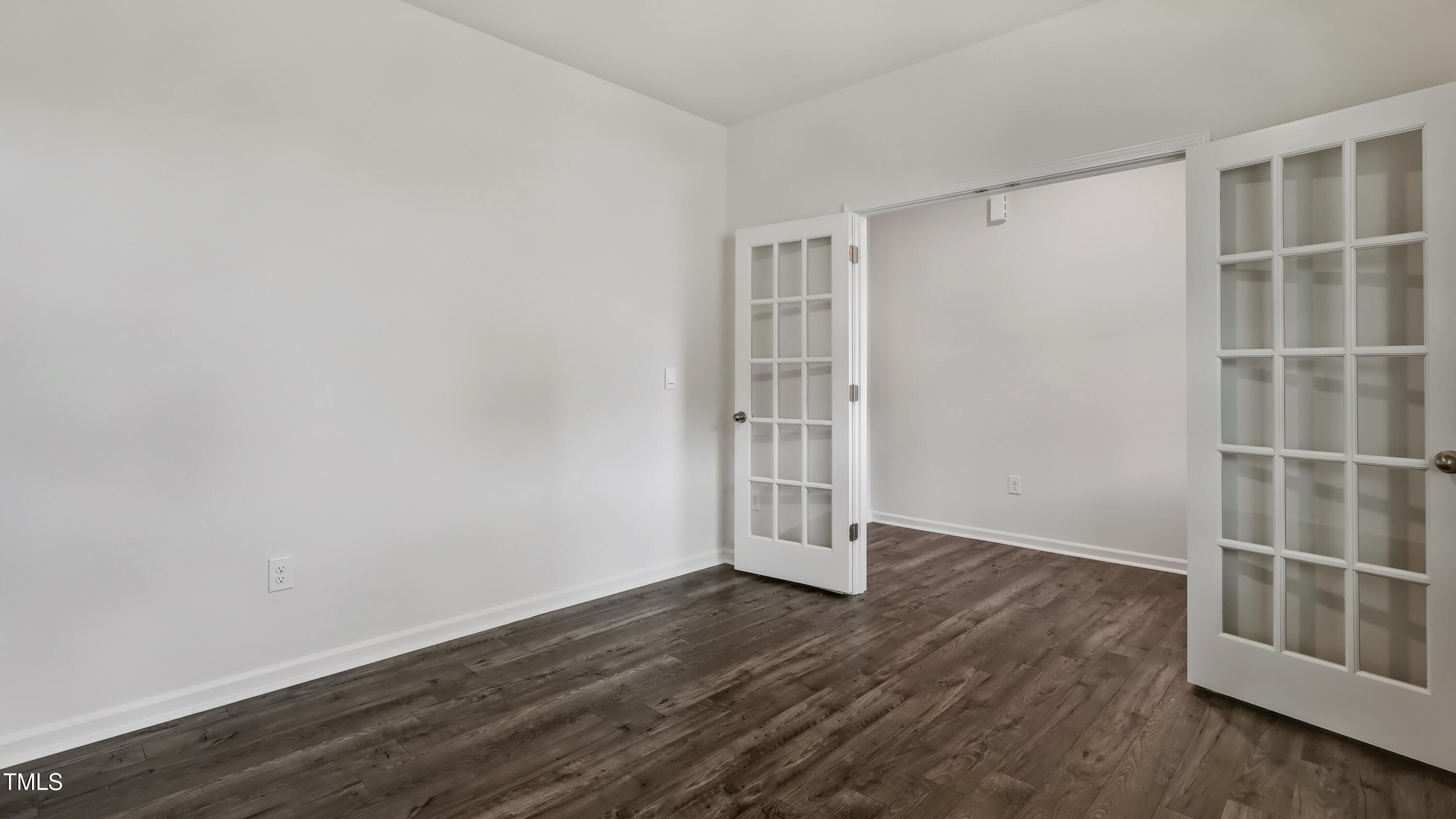 821 Comice Pear Way Willow Spring, NC 27592 - Photo 4 of 36 an empty room with wooden floor and empty shelves