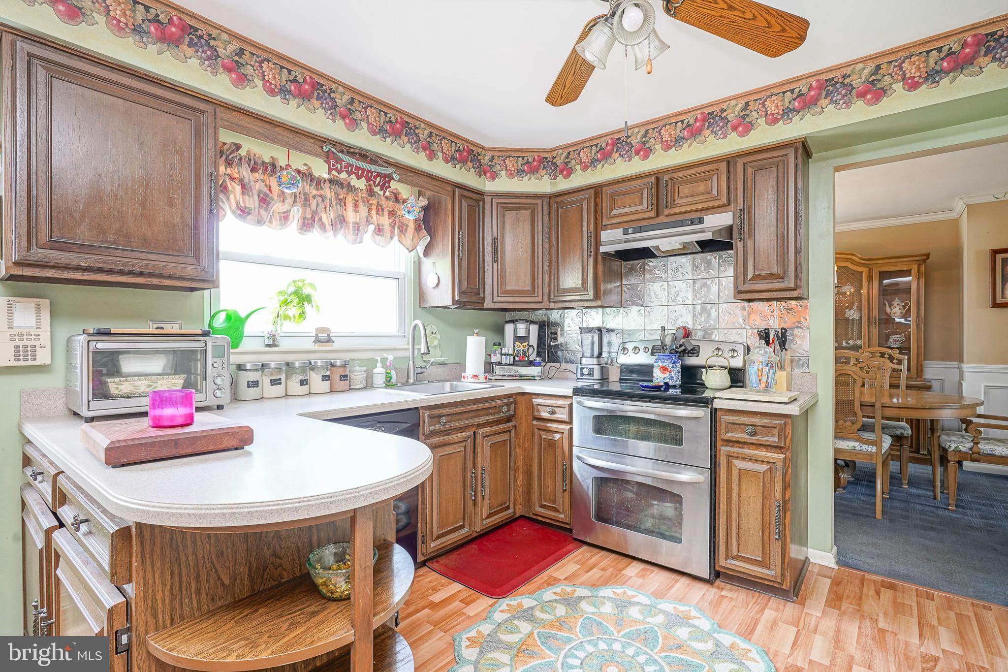 118 Golfview Drive Sewell, NJ 08080 - Photo 11 of 39 a kitchen with stainless steel appliances granite countertop a sink dishwasher and cabinets with wooden floor