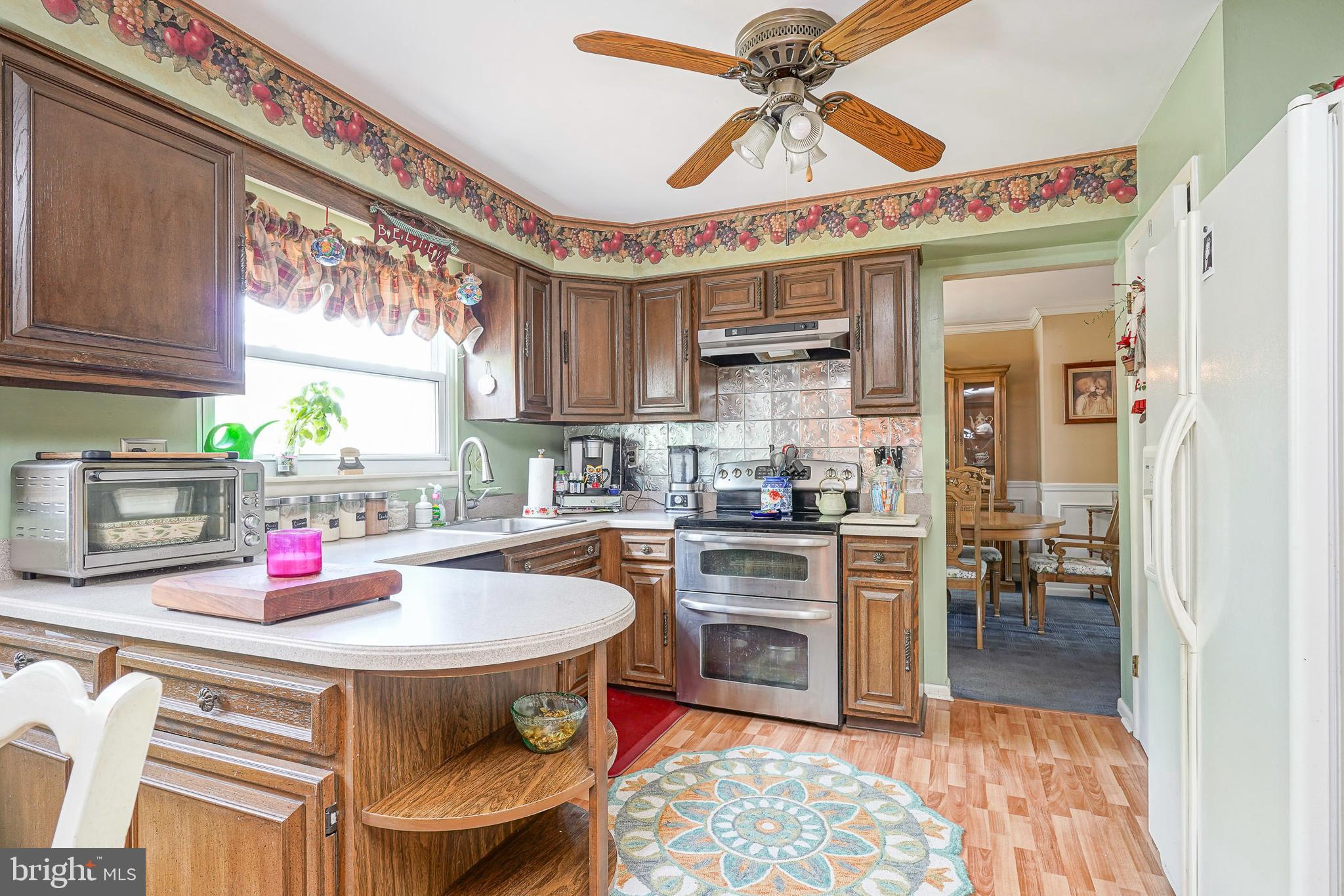 118 Golfview Drive Sewell, NJ 08080 - Photo 14 of 39 a kitchen with stainless steel appliances granite countertop a dining table chairs sink and cabinets
