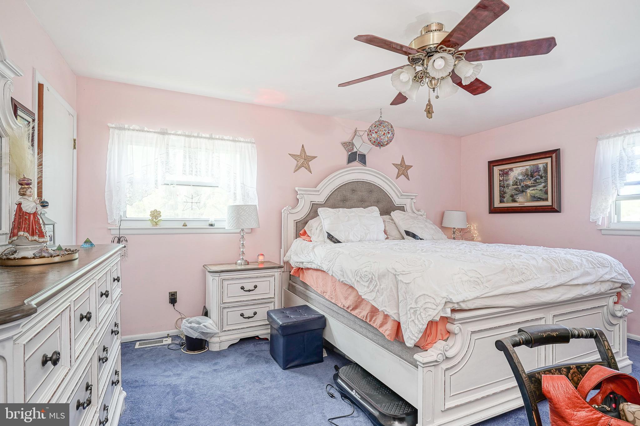 118 Golfview Drive Sewell, NJ 08080 - Photo 29 of 39 a bedroom with a bed a chandelier and a dresser