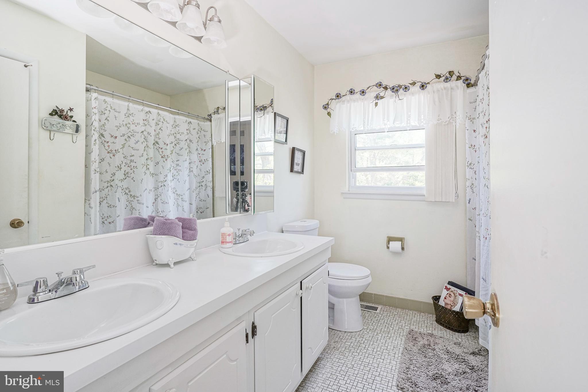 118 Golfview Drive Sewell, NJ 08080 - Photo 31 of 39 a bathroom with a double vanity sink toilet and a mirror
