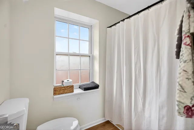 a living room with furniture gym equipment and a window