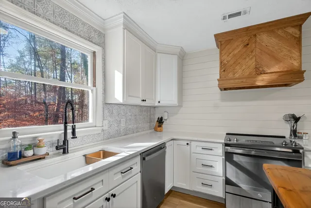 a kitchen with a sink cabinets and window